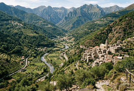 Mountain valley with winding river, terraced fields, village, and jagged peaks